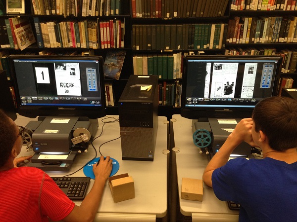THATClass students reading microfilmed newspapers. THATClass